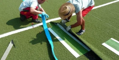 Укладка искусственной травы на футбольное поле с разметкой врезкой